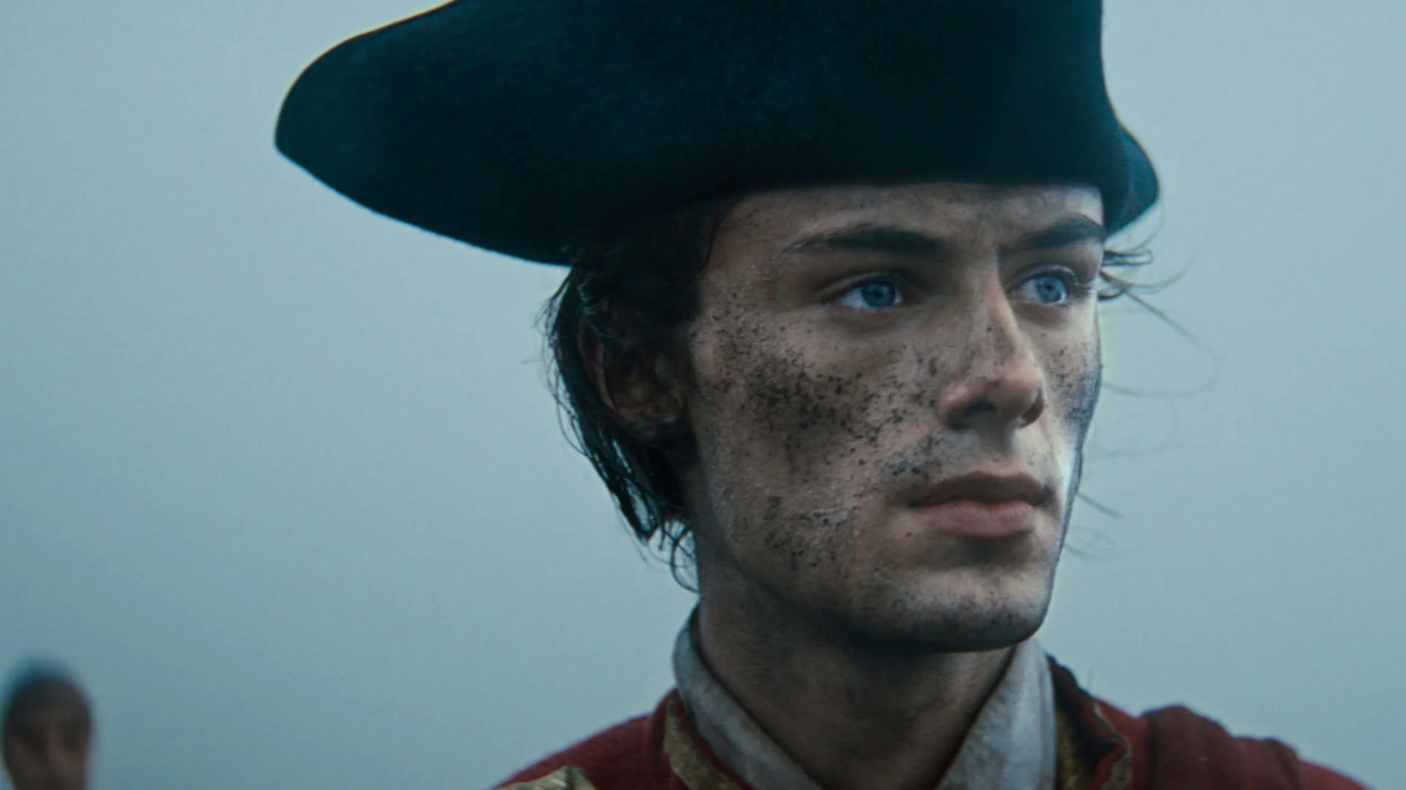 A young George Washington, face streaked with battle, gazing toward the horizon in cold morning mist.